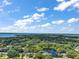Expansive aerial view of a large, lush parcel featuring mature trees and a serene pond, bordered in blue at 3630 Oak St, Mount Dora, FL 32757