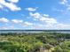 Picturesque aerial shot featuring lush, mature trees enveloping a serene pond and distant lake views at 3630 Oak St, Mount Dora, FL 32757