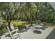 Landscaped backyard with mature trees, patio, and outdoor seating at 3630 Oak St, Mount Dora, FL 32757