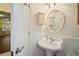 Charming bathroom with pedestal sink, round mirror, and floral-painted medicine cabinet at 3630 Oak St, Mount Dora, FL 32757