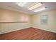 Versatile bonus room with wood flooring, track lighting, a window, and shelving offering a flexible space for various uses at 3630 Oak St, Mount Dora, FL 32757