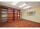 Large bonus room with wood floors, ample shelving, a window, and bright lighting offering a versatile space at 3630 Oak St, Mount Dora, FL 32757