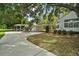 Long driveway leading to a home with a carport and a well-maintained lawn at 3630 Oak St, Mount Dora, FL 32757