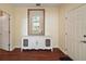 Inviting entryway with wooden floors, a console table with mirror, and views to other rooms at 3630 Oak St, Mount Dora, FL 32757