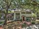 Charming two-story home with mature trees, shutters, brick walkway, and manicured landscaping at 3630 Oak St, Mount Dora, FL 32757