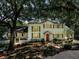 Stately two-story home with mature trees, shutters, brick walkway, and manicured landscaping at 3630 Oak St, Mount Dora, FL 32757