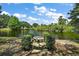 Scenic exterior view with a pond and table in a well-manicured backyard oasis at 3630 Oak St, Mount Dora, FL 32757