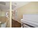 Bright hallway with wood floors, white trim, complemented by a white piano and decorative wall art for a touch of elegance at 3630 Oak St, Mount Dora, FL 32757