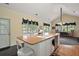 Bright kitchen with butcher block island, white cabinets, modern appliances, and view to eat-in area at 3630 Oak St, Mount Dora, FL 32757
