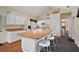 Bright kitchen featuring a central island with barstool seating, views of other rooms, and white cabinetry at 3630 Oak St, Mount Dora, FL 32757