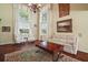Comfortable living room featuring tall windows, hardwood floors, and a classic chandelier at 3630 Oak St, Mount Dora, FL 32757