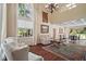Spacious living room with large windows, hardwood floors, and comfortable seating arrangements at 3630 Oak St, Mount Dora, FL 32757