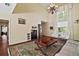 Cozy living room with hardwood floors, a large rug, and views of other areas in the home at 3630 Oak St, Mount Dora, FL 32757