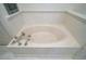 A close up of the bathtub in the main bathroom, which has vintage fixtures and white wainscotting at 3630 Oak St, Mount Dora, FL 32757