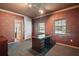 Office with rich wallpaper, desk with ample storage, and natural light from two windows at 3630 Oak St, Mount Dora, FL 32757