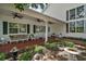 Inviting covered porch with wicker seating and a view of the beautifully landscaped backyard at 3630 Oak St, Mount Dora, FL 32757