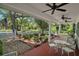 Inviting porch features neutral furniture, brick pavers, and beautifully landscaped backyard at 3630 Oak St, Mount Dora, FL 32757