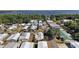 An aerial view shows a community of homes situated near a scenic lake at 37945 Monticello St, Leesburg, FL 34788