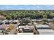 An aerial view shows homes in a community surrounded by lush greenery at 37945 Monticello St, Leesburg, FL 34788