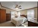 Bedroom with soft lighting, ceiling fan and neutral tones, plus a dresser at 37945 Monticello St, Leesburg, FL 34788