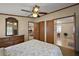 Bedroom features a patterned comforter, ceiling fan and two closets at 37945 Monticello St, Leesburg, FL 34788