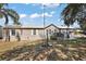 Inviting single-story home with white trim, a metal roof, and well-maintained front yard at 37945 Monticello St, Leesburg, FL 34788