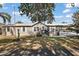 Charming single-story home featuring a metal roof, covered parking, and landscaped front yard at 37945 Monticello St, Leesburg, FL 34788