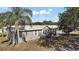 Charming home with a metal roof, mature trees, and well-maintained landscaping at 37945 Monticello St, Leesburg, FL 34788