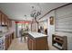 Bright kitchen with wood cabinets, center island, and eat-in area with dining table at 37945 Monticello St, Leesburg, FL 34788