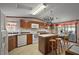 Well-lit kitchen featuring wood cabinets, island with seating, and appliances at 37945 Monticello St, Leesburg, FL 34788