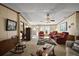 Spacious living room with classic decor, ceiling fan, and comfortable seating arrangement at 37945 Monticello St, Leesburg, FL 34788