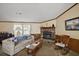 Comfortable living room featuring a fireplace, sofa, and view to the outside at 37945 Monticello St, Leesburg, FL 34788
