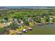 An aerial view of beautiful waterfront homes with private docks, surrounded by lush trees and lake views at 38420 Langlois Pl, Leesburg, FL 34788