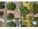 An overhead aerial shot of waterfront homes with boat docks, lush trees, and paved driveways at 38420 Langlois Pl, Leesburg, FL 34788