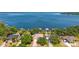 An aerial view of waterfront homes with private docks on a stunning lake, surrounded by lush greenery at 38420 Langlois Pl, Leesburg, FL 34788