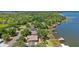 An aerial view of waterfront homes with private docks, with lush greenery and lake views at 38420 Langlois Pl, Leesburg, FL 34788
