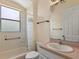 Bathroom features a bathtub with shower, a toilet, and a vanity with a sink and mirror at 38420 Langlois Pl, Leesburg, FL 34788