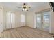Bright bedroom with natural light, ceiling fan, and sliding doors to the outdoors at 38420 Langlois Pl, Leesburg, FL 34788