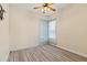 Bedroom with a ceiling fan and large window, and wood-look flooring at 38420 Langlois Pl, Leesburg, FL 34788