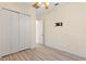 Bedroom with a closet, ceiling fan, wood-look floors, and a TV mount on the wall at 38420 Langlois Pl, Leesburg, FL 34788