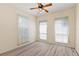 Cozy bedroom with a ceiling fan and three windows that let in plenty of light at 38420 Langlois Pl, Leesburg, FL 34788