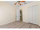 The bedroom features wood-look floors, a ceiling fan, and a closet at 38420 Langlois Pl, Leesburg, FL 34788