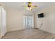 Bright bedroom features a ceiling fan, and sliding glass doors to the outside at 38420 Langlois Pl, Leesburg, FL 34788