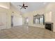 Spacious living area with tile floors, a fireplace, and sliding glass doors offering picturesque lake views at 38420 Langlois Pl, Leesburg, FL 34788