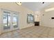 Water view living room with fireplace, natural light through large windows and double doors at 38420 Langlois Pl, Leesburg, FL 34788