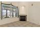 Cozy fireplace nook in a room with views of the lake and access to the outdoor area at 38420 Langlois Pl, Leesburg, FL 34788