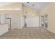 Spacious living room with tile flooring and access to the outdoors through double doors at 38420 Langlois Pl, Leesburg, FL 34788