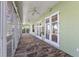 Enclosed sunroom with tiled floors and multiple doors offering views of the outdoors at 38420 Langlois Pl, Leesburg, FL 34788