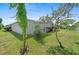 Beautiful backyard with mature trees and lush green lawn, showcasing the home's outdoor space at 432 King Way, Tavares, FL 32778
