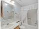 A clean bathroom featuring a shower with white curtain, toilet, mirror and sink at 432 King Way, Tavares, FL 32778